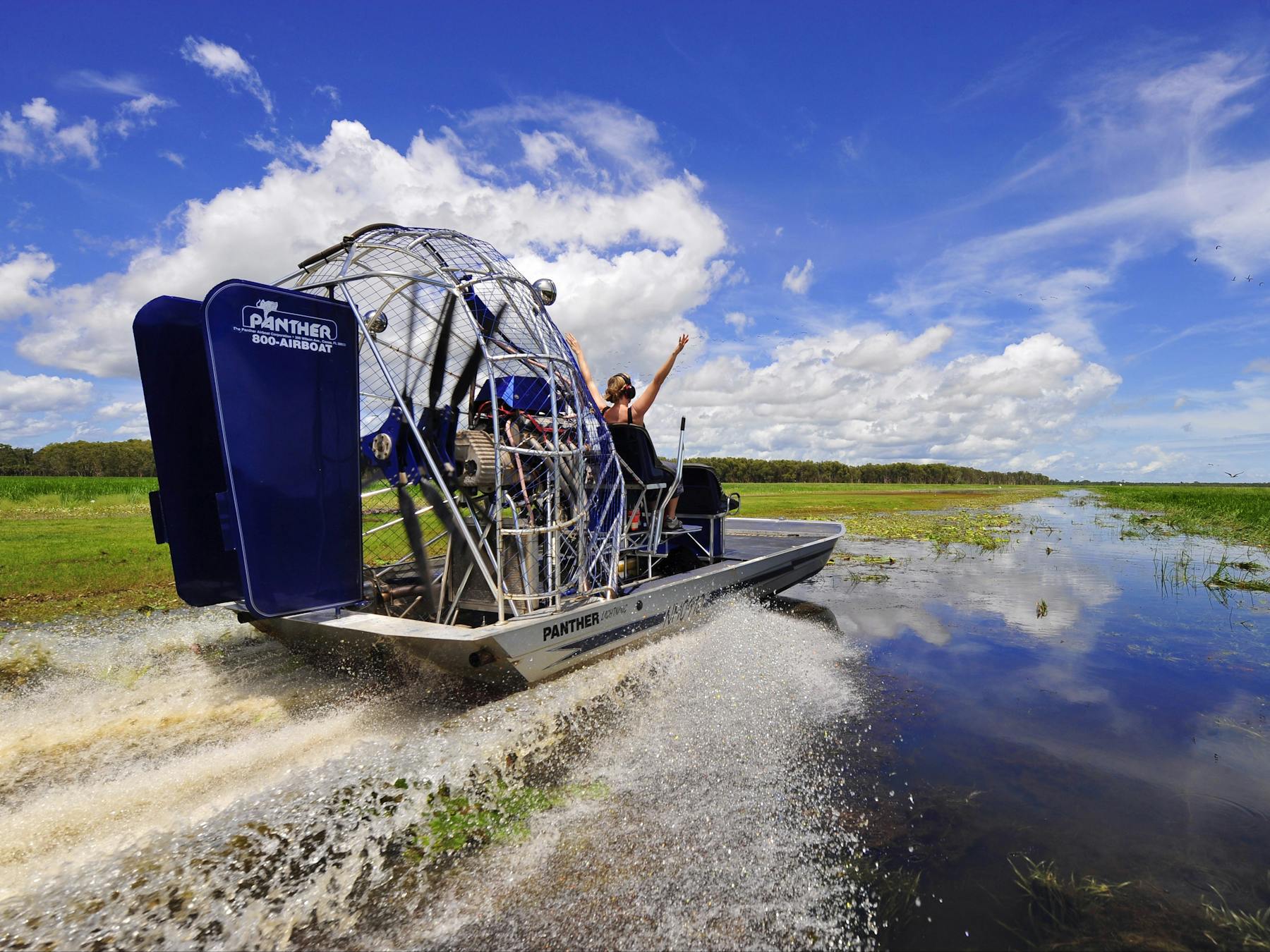 Action shot of people air boating down Mary River