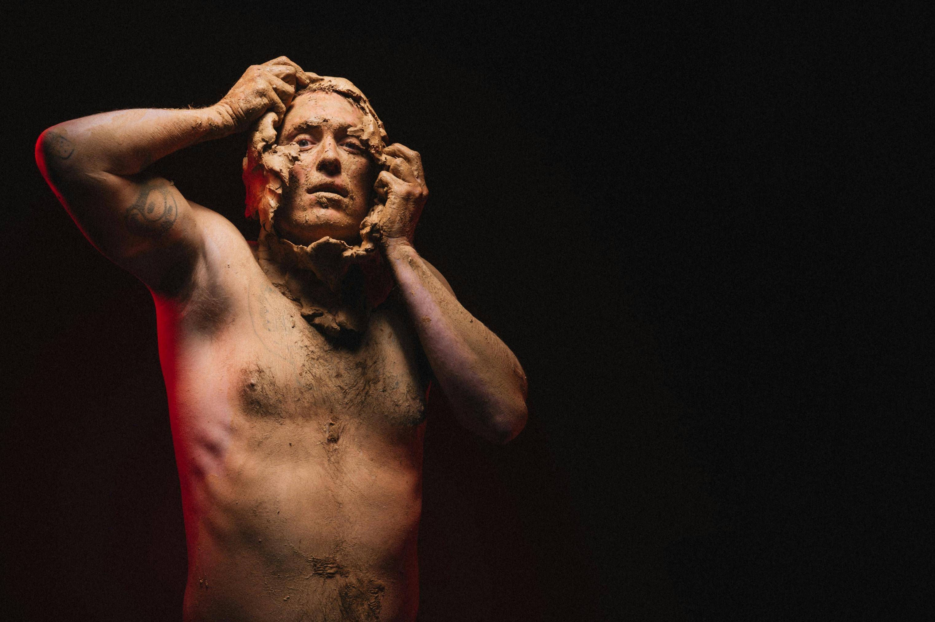 A man peels a class mask off from around his head.