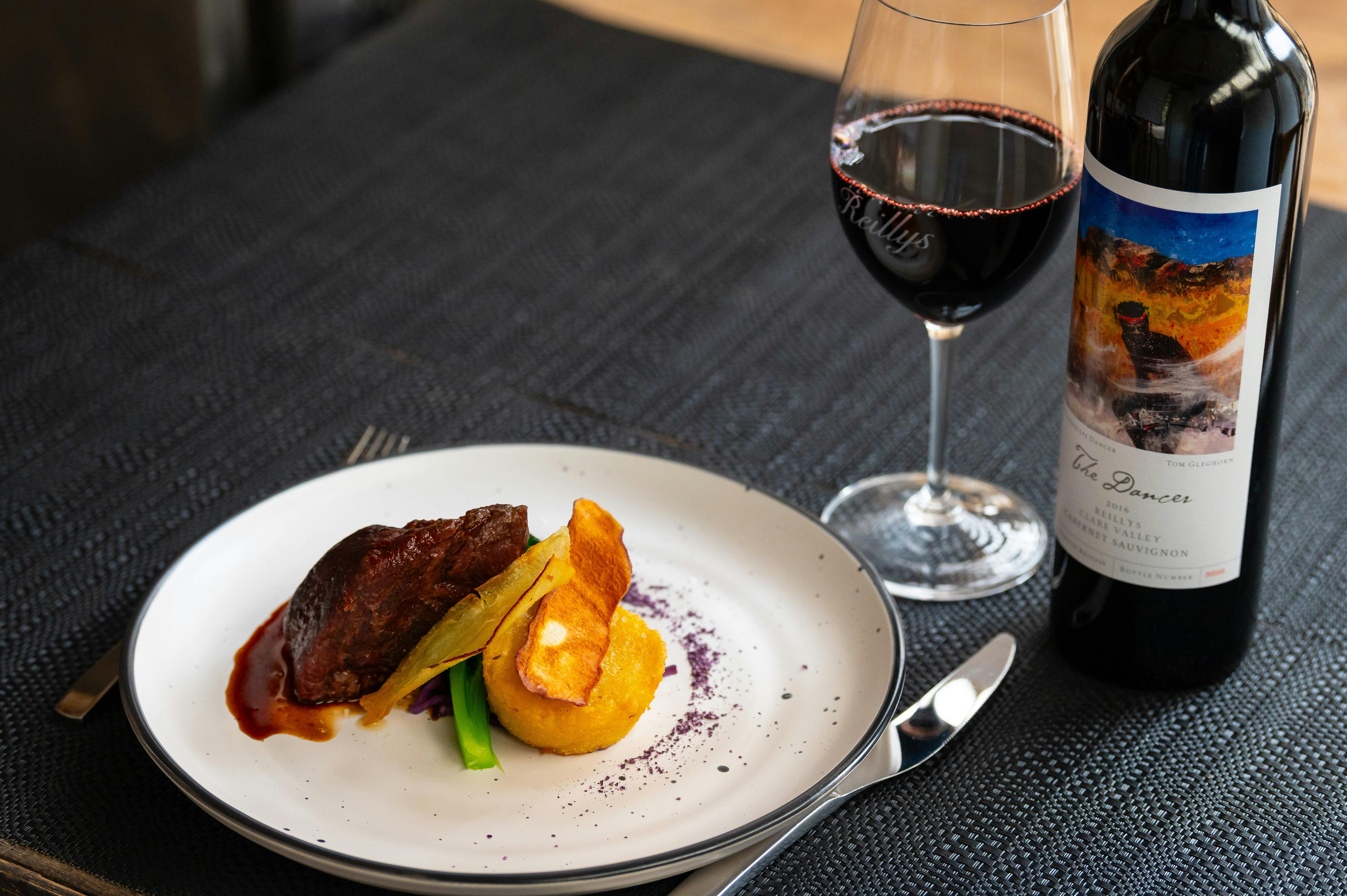 Main dish with lamb and vegetables with a glass of premium Reillys Clare Valley Cabernet Sauvignon