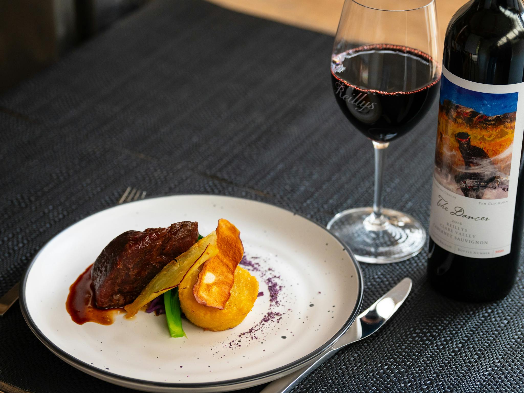 Main dish with lamb and vegetables with a glass of premium Reillys Clare Valley Cabernet Sauvignon