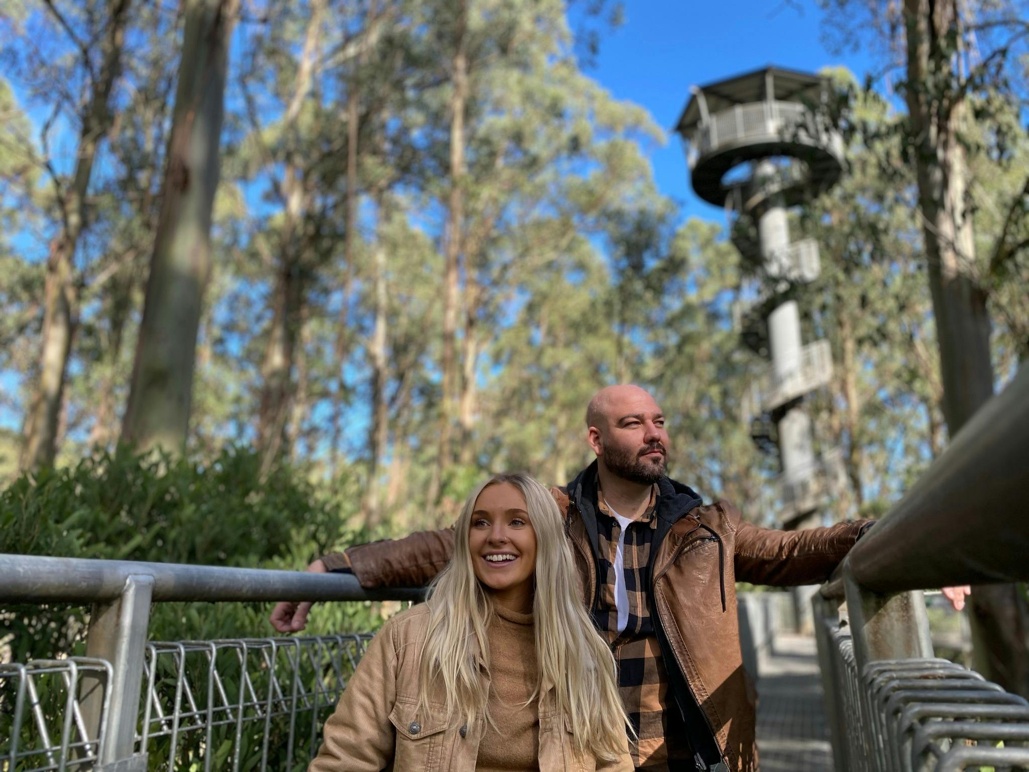 Two people standing on a bridge