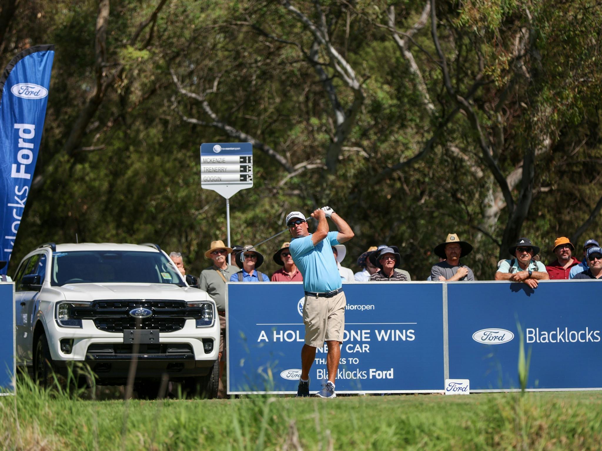 Golfer teeing off on the Hole in One Hole