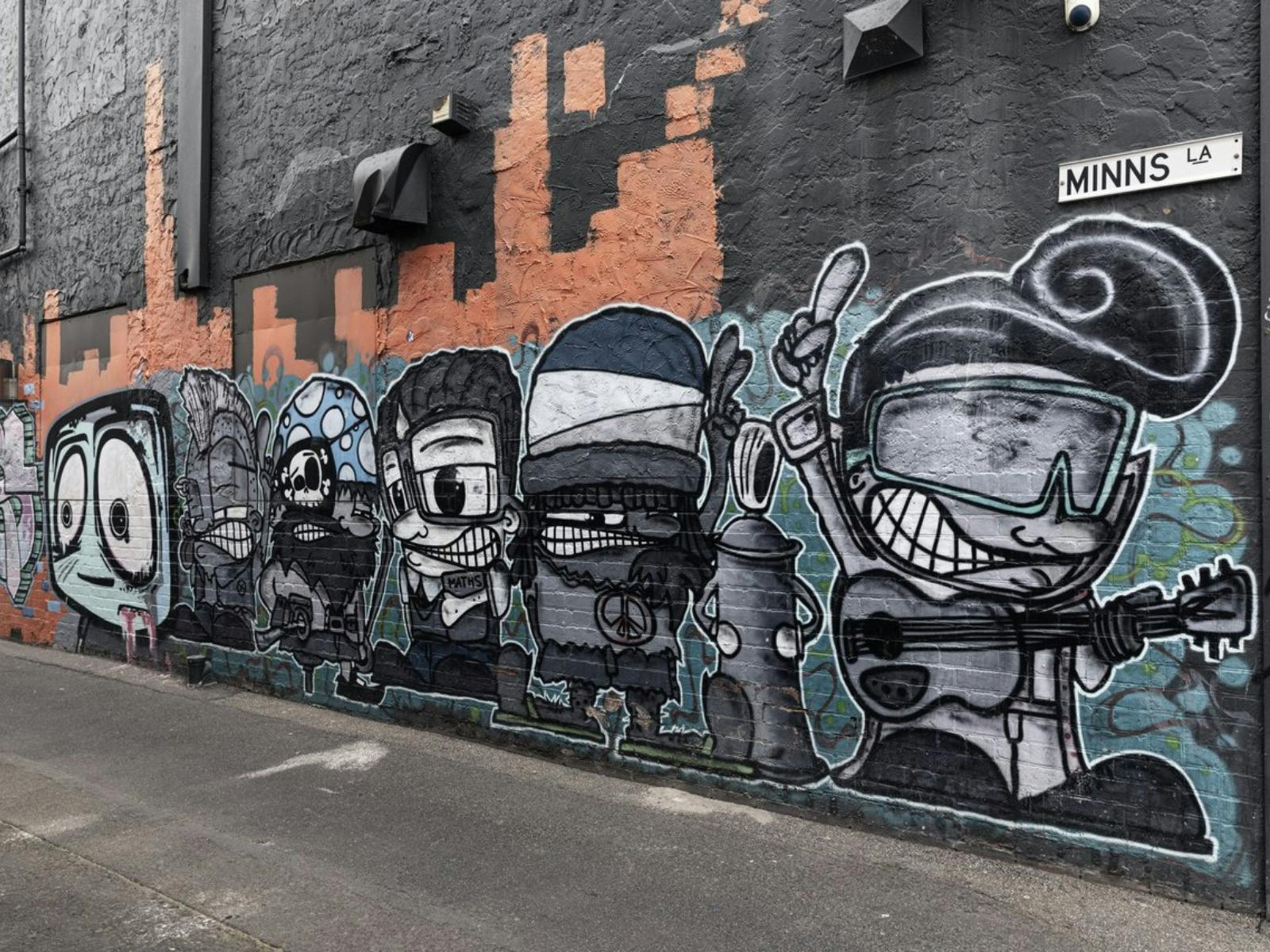 little cartoon artworks of people on brick wall