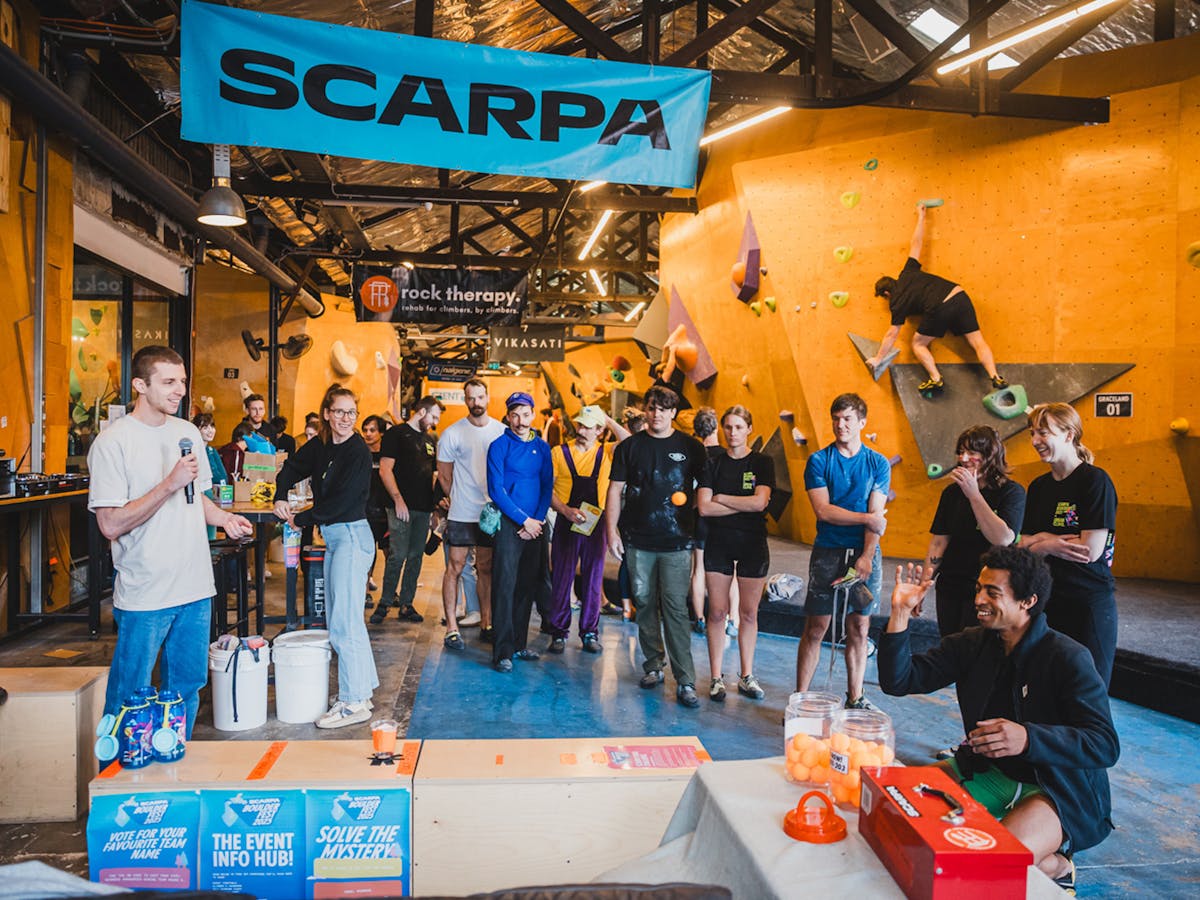 An emcee is announcing then entrants and attempts of a Nalgene bottle, ping-pong toss challenge