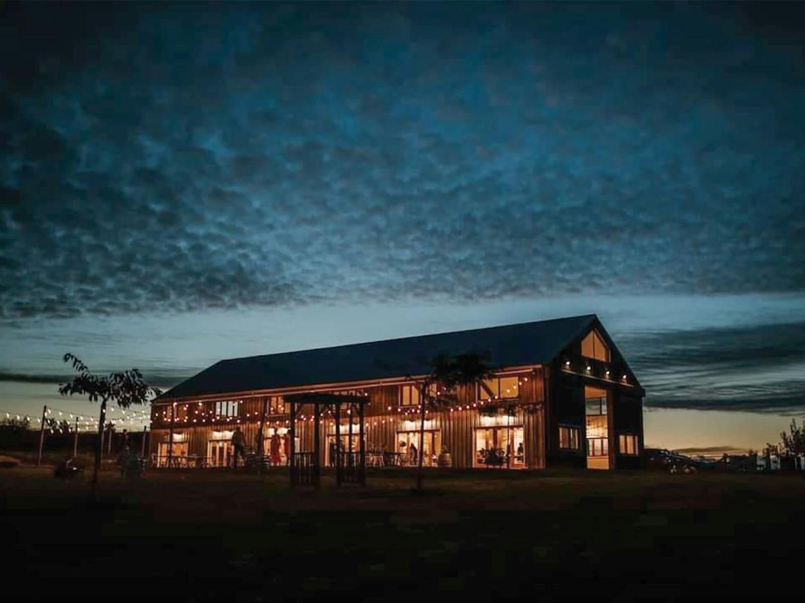 An image of Mount Gnomon Farm during the evening, with a view of the night sky.