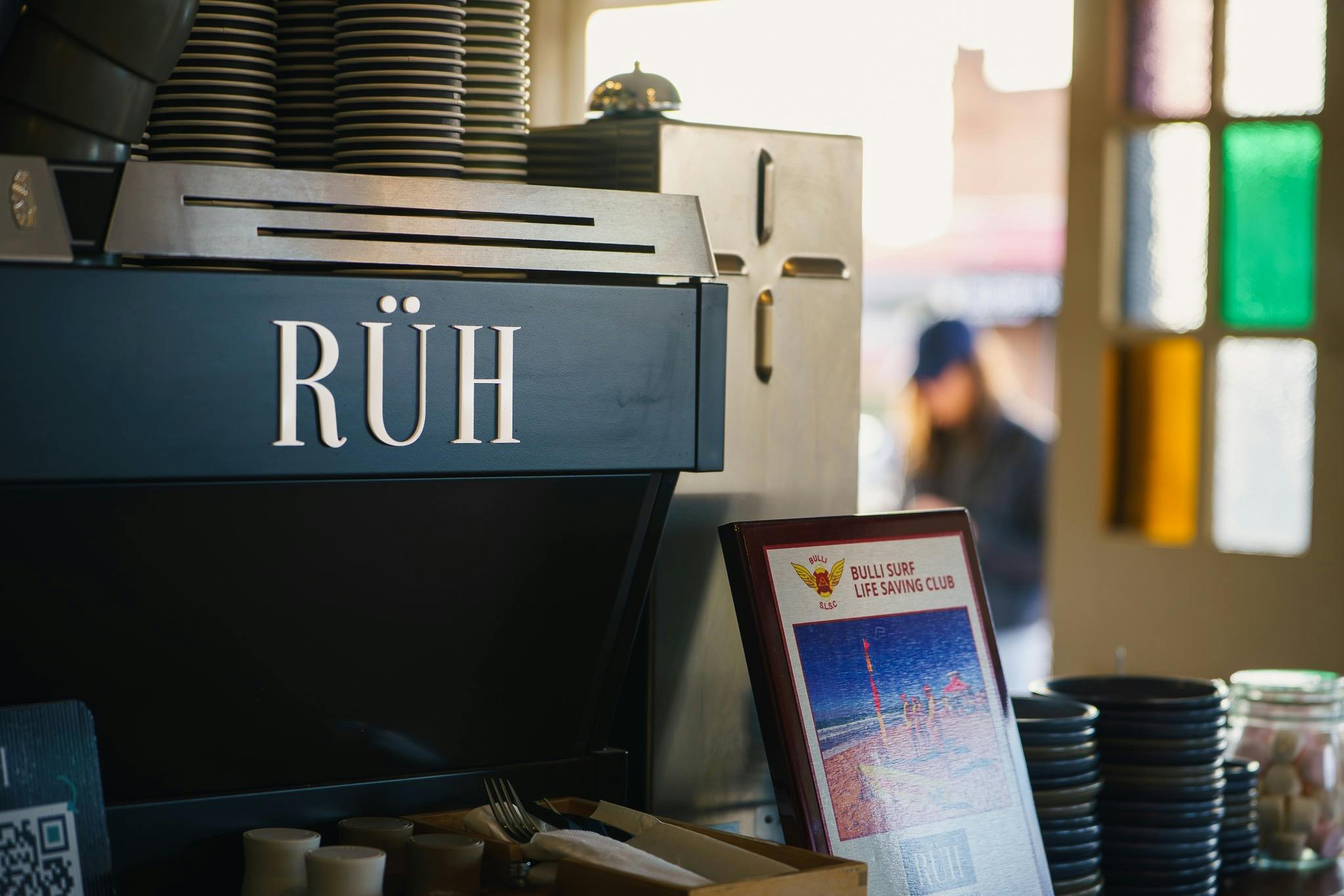 Coffee machine with the brand RÜH and a plaque received from Bulli SLSC acknowledging our support.