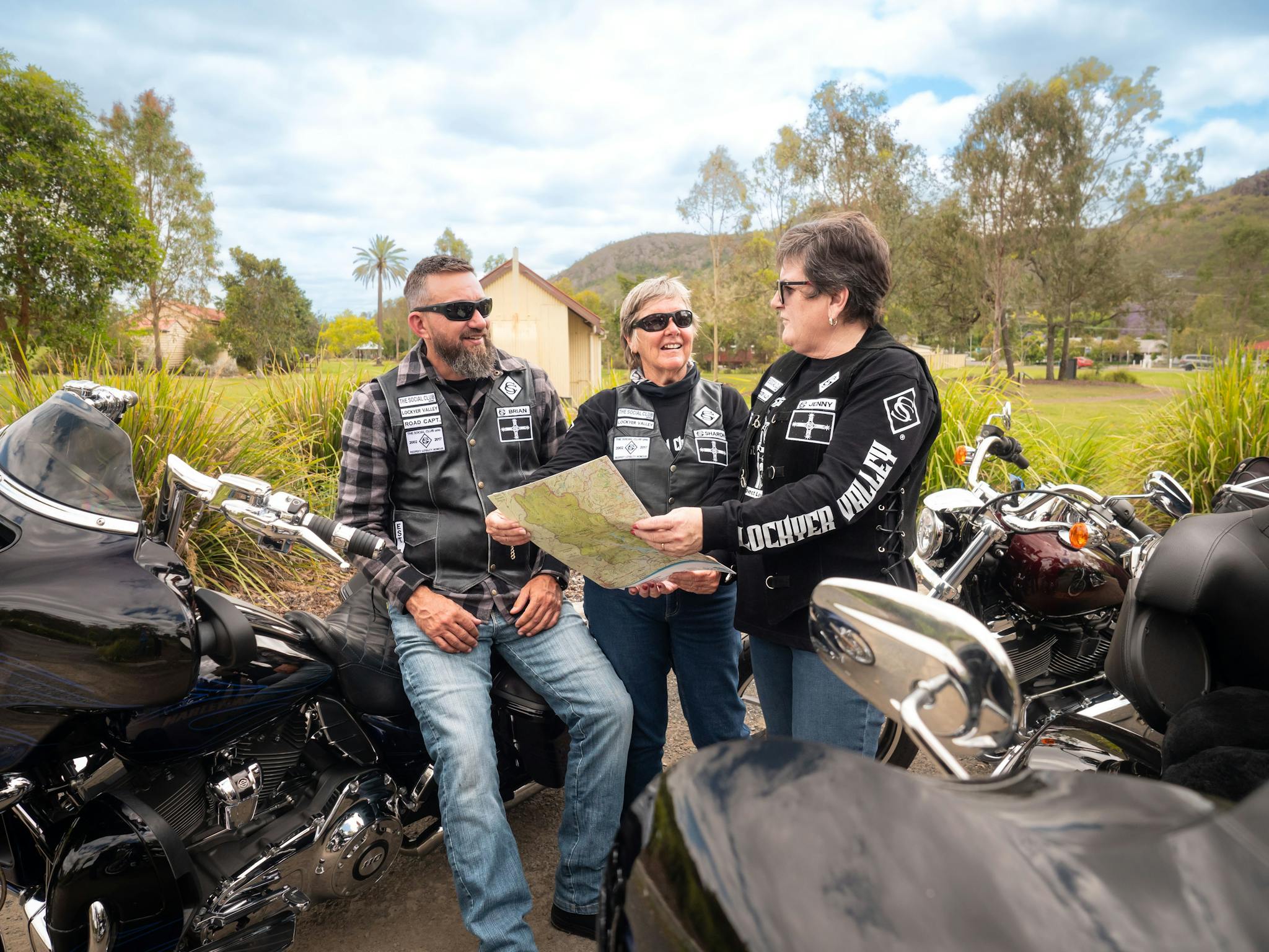 Motorcyclists looking at Map in Pipeliner Park in Esk, Somerset Motorcyclists looking at Map in Pipeliner Park in Esk, Somerset