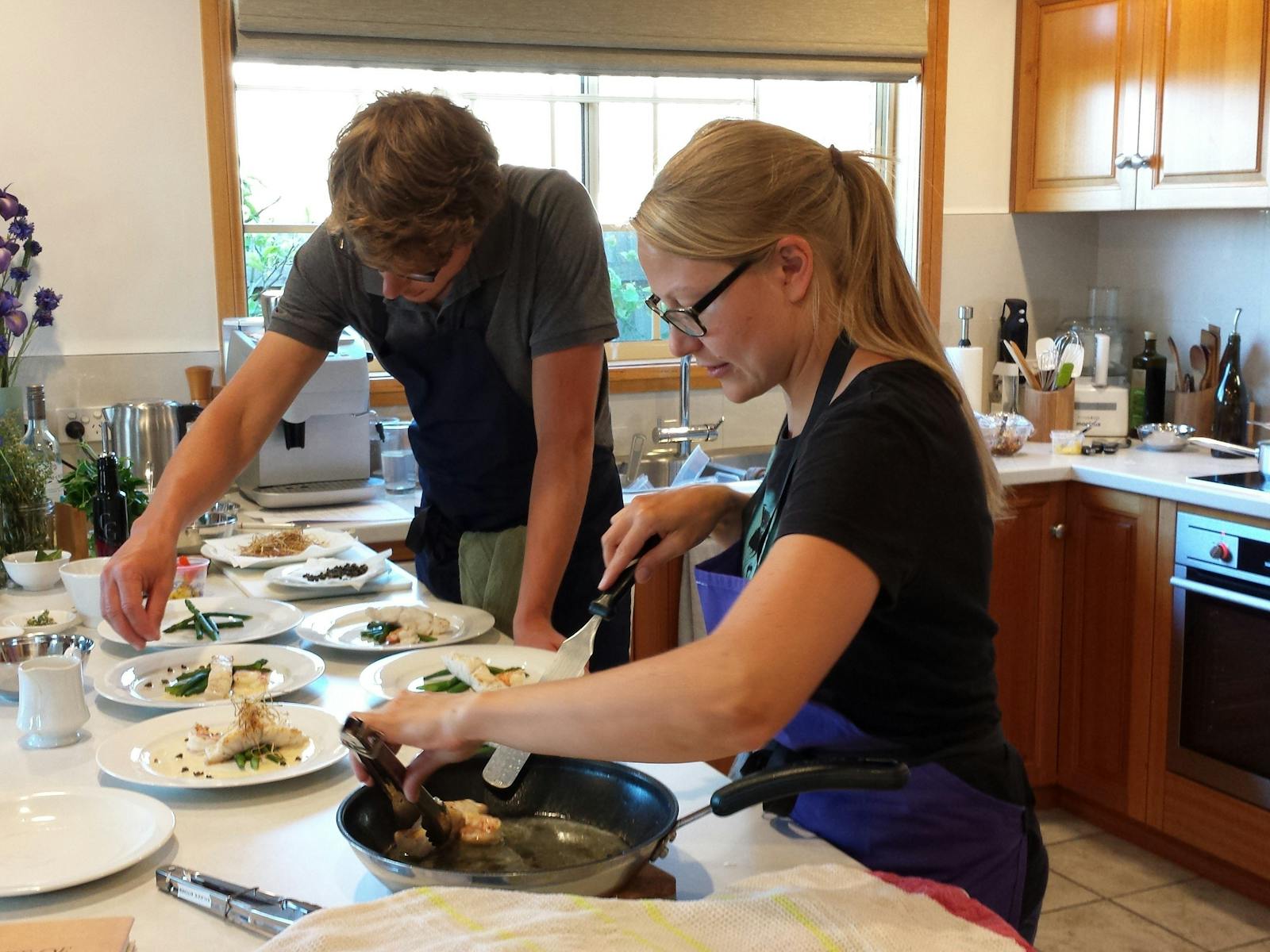 Students preparing seafood dishes in Sylvia's Sensation Seafood Class