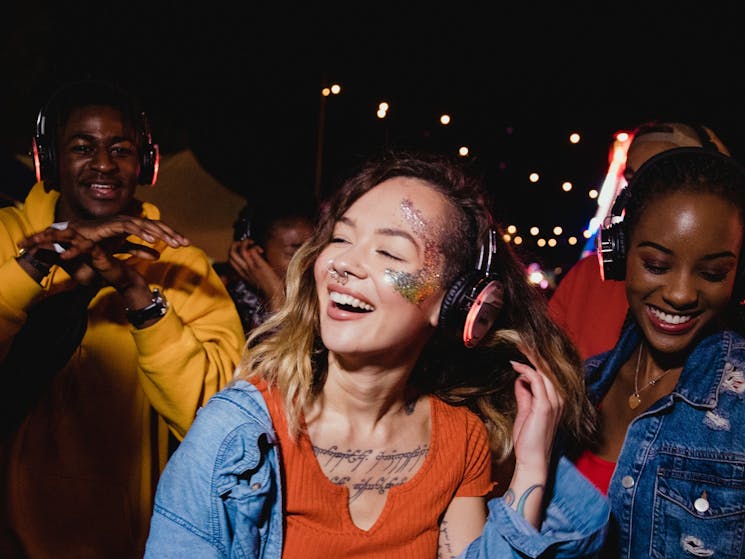 A group of people enjoying themselves wearing headphones
