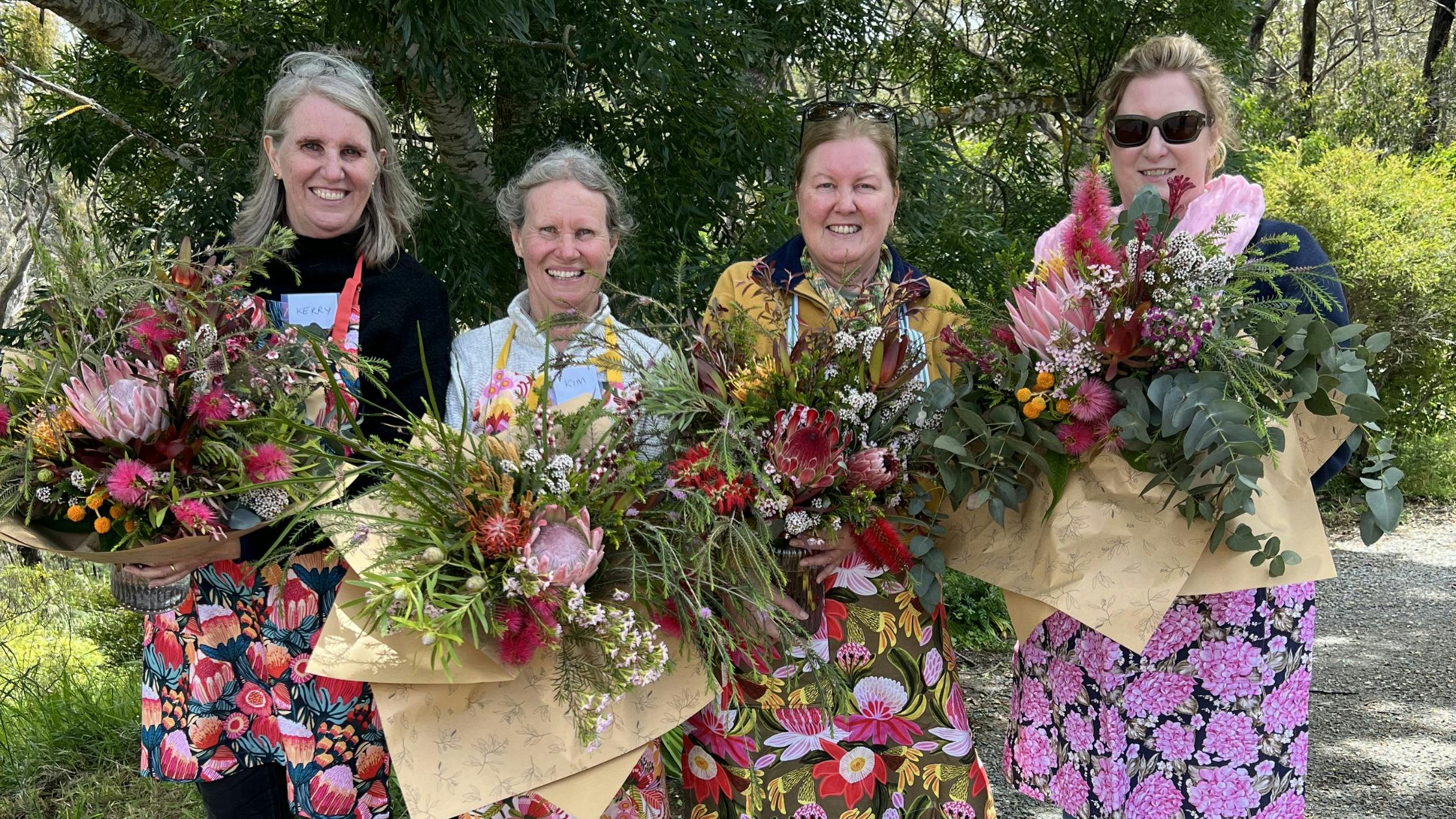 Workshop participants showcasing their unique bouquet creations
