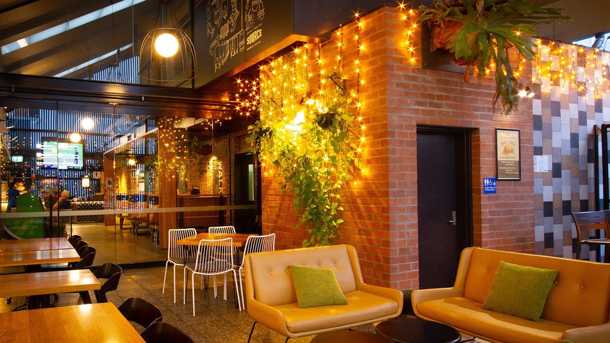 A table and chairs, faily lights and lots of plants.