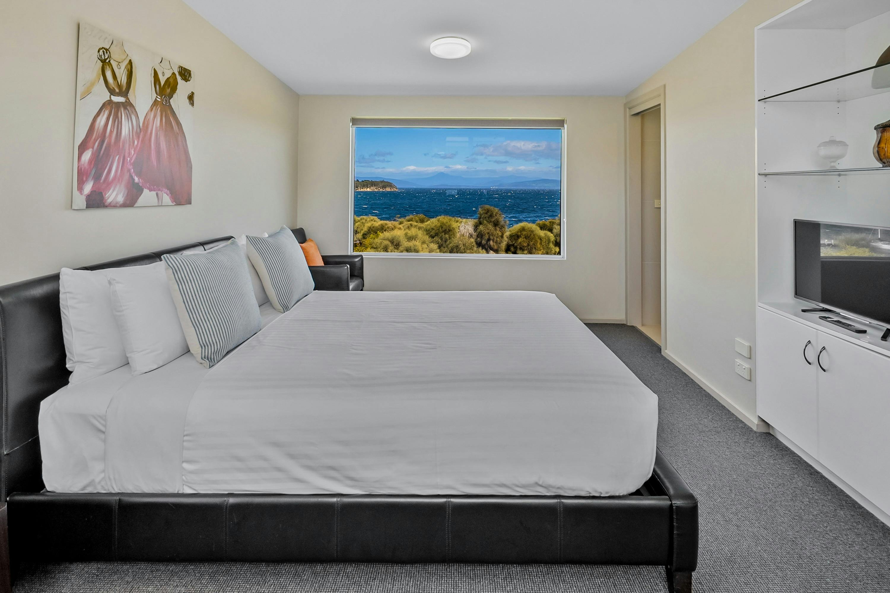 Master bedroom with queen-size bed and reading chair