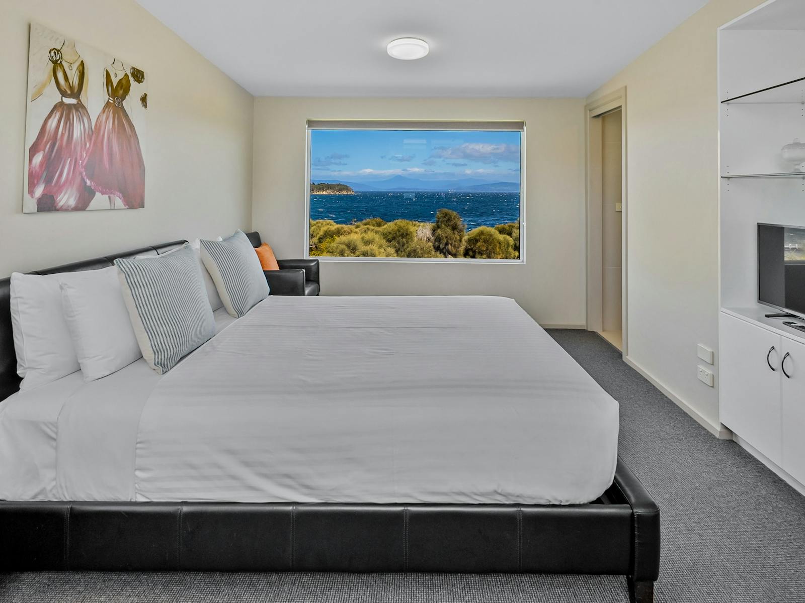 Master bedroom with queen-size bed and reading chair
