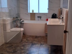 Main Bathroom with walk in shower and bath