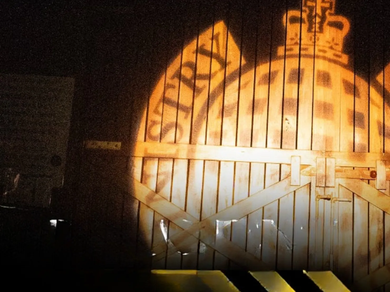 logo reflected through light on a wooden door