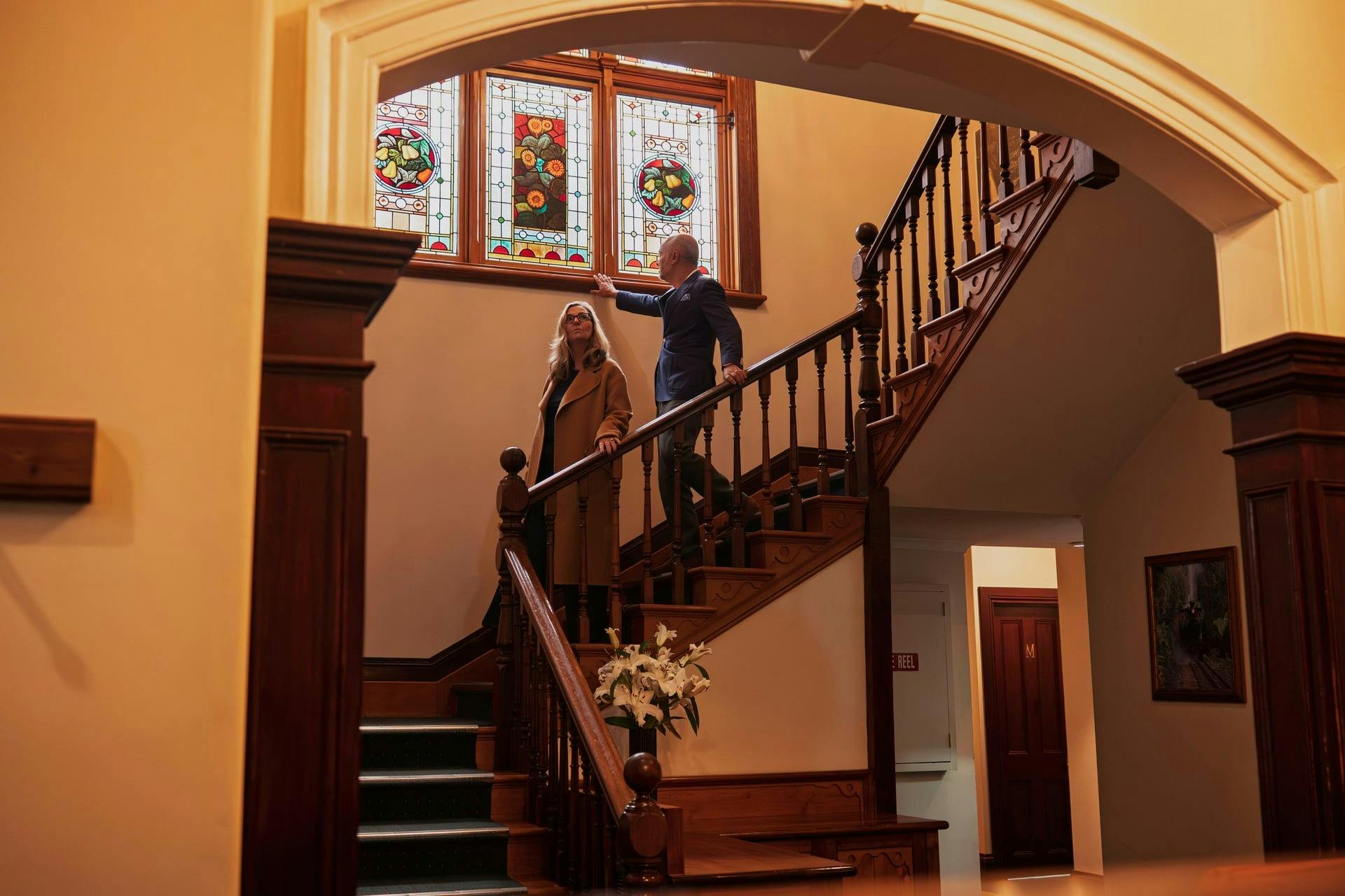 Guest walking down stair way in Franklin Manor