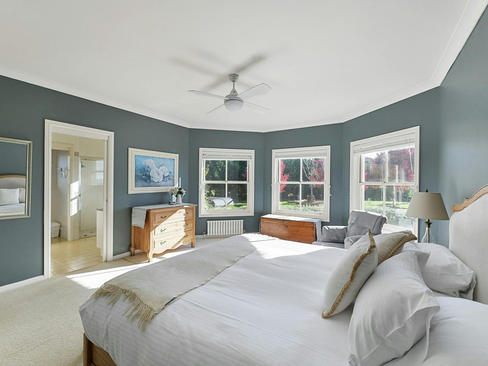 Main bedroom with king bed and ensuite, and blue walls