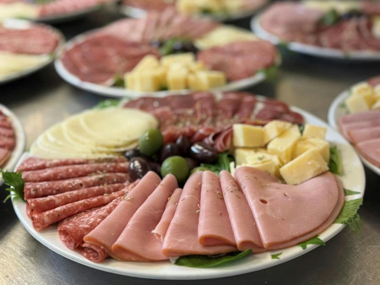 Ham, Salami Cheeses and Olives on a plate