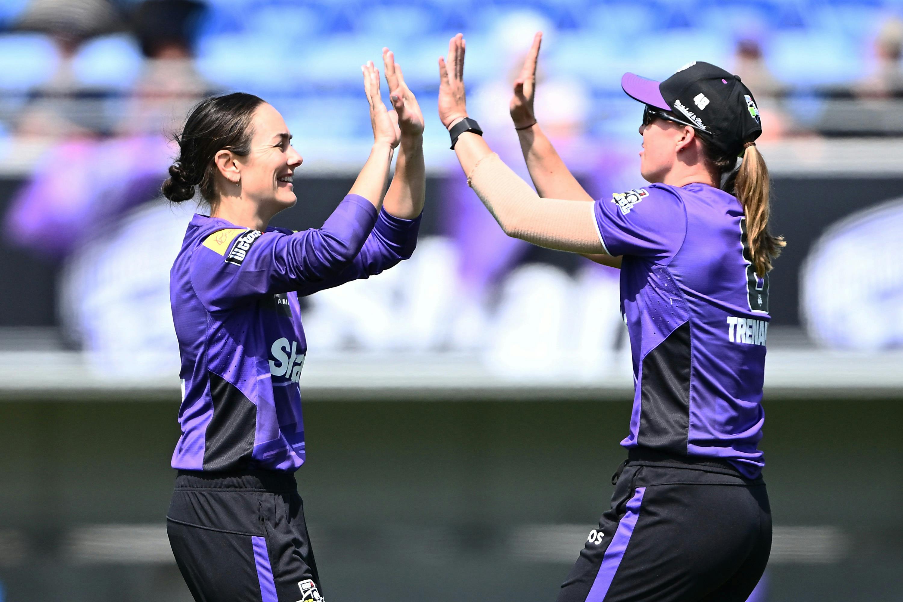 Two players celebrating in the WBBL