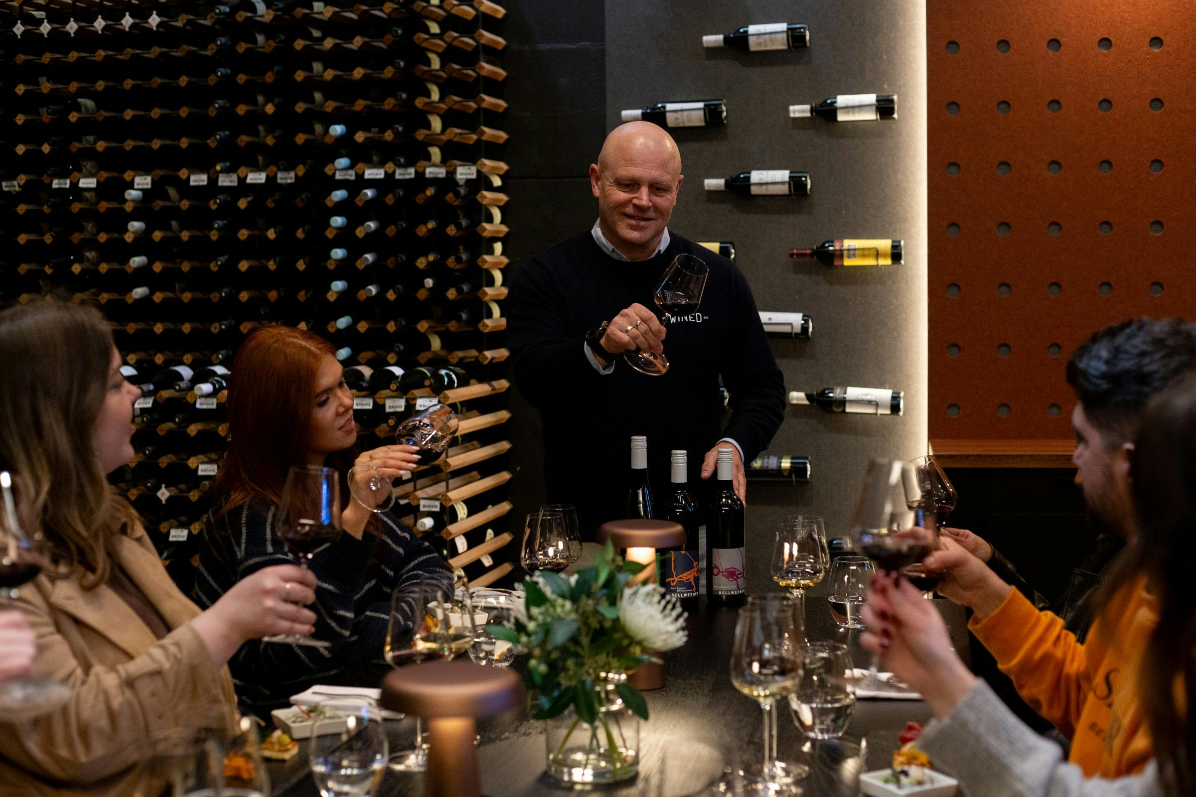 sommelier guiding guests through tasting