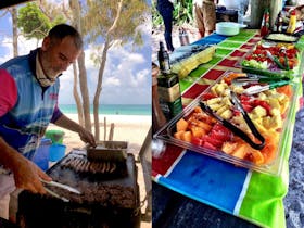 man cooking bbq on whitehaven beach