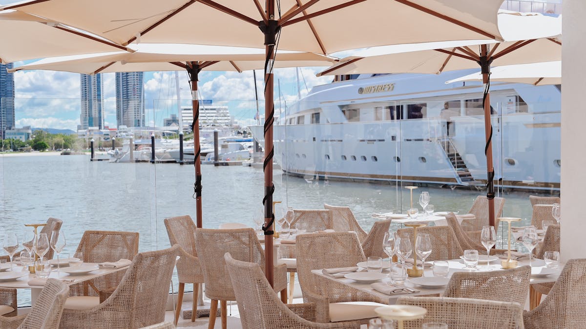 Dining seating at MĀRE with marina views
