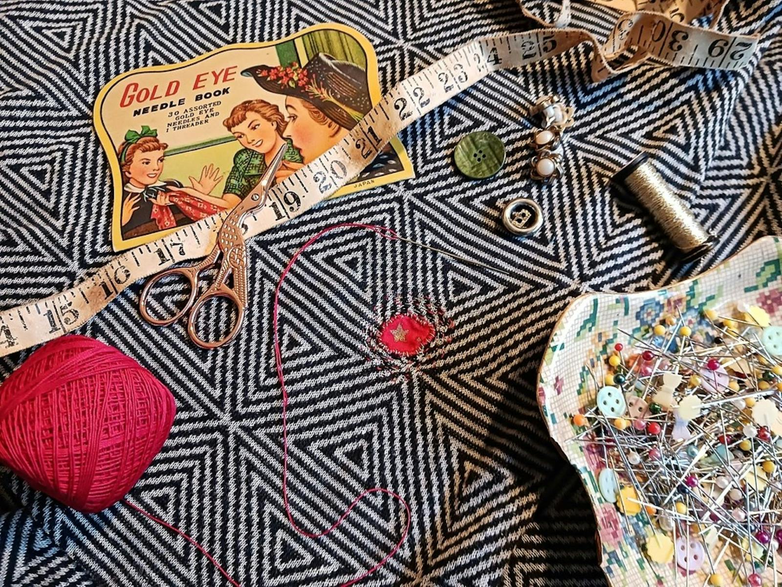 Needle, thread, scissors and materials