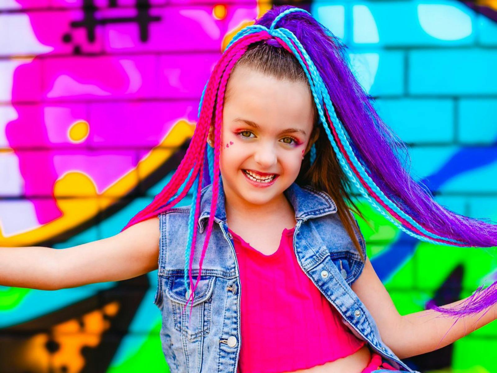 Girl with long braid colourful extensions