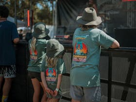 Three kids watching the bands on stage at Caltowie COFU