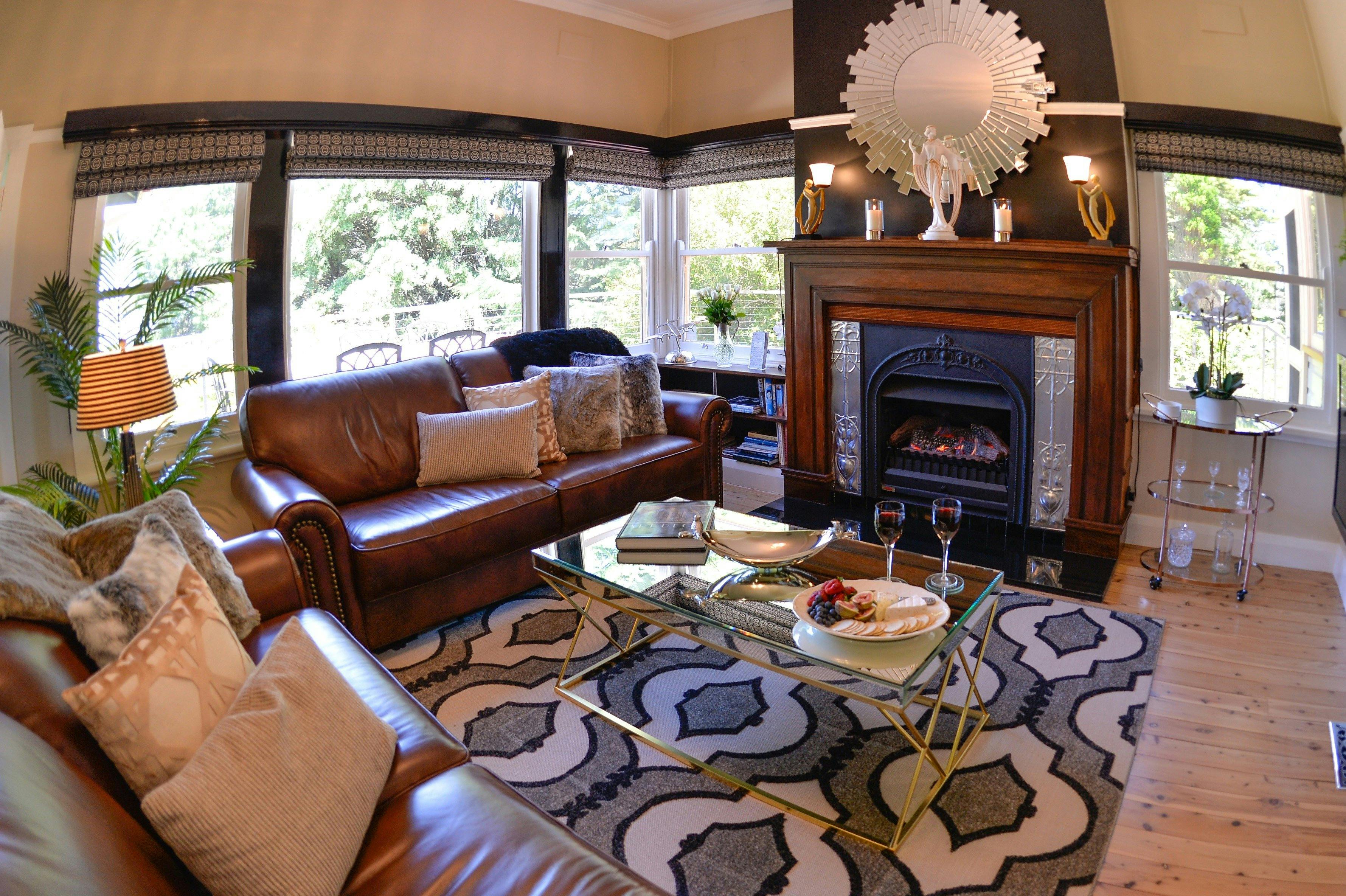 Plush leather lounge room with gas-log fireplace and views across the Jamison Valley