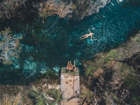 Aerial view of people swimming in thermal pool