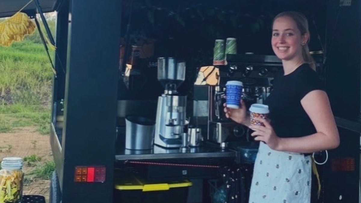 girl holding coffee cups smiling