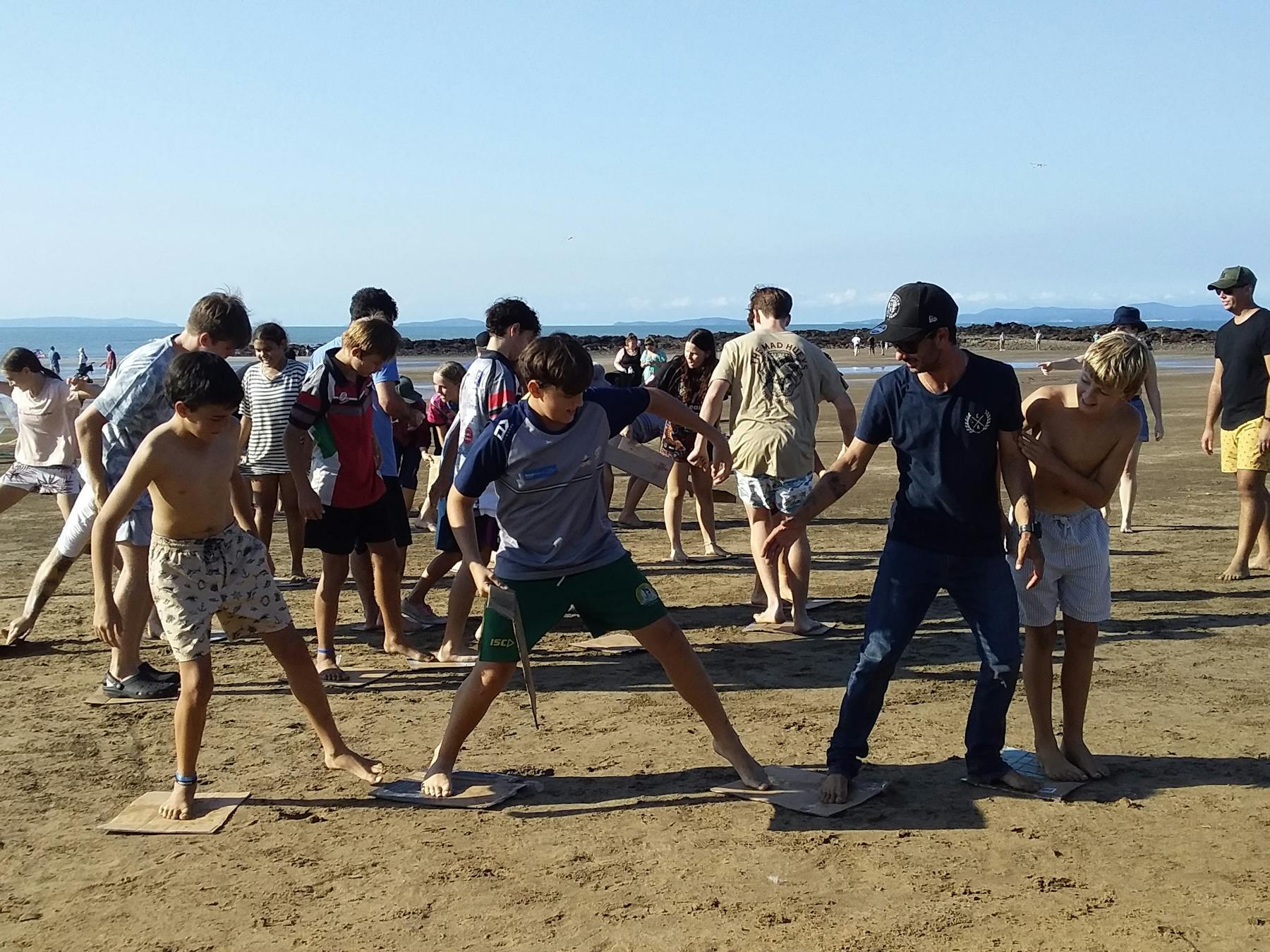 Teams vying for a prize at the beach games. Teams need to work together to achieve.