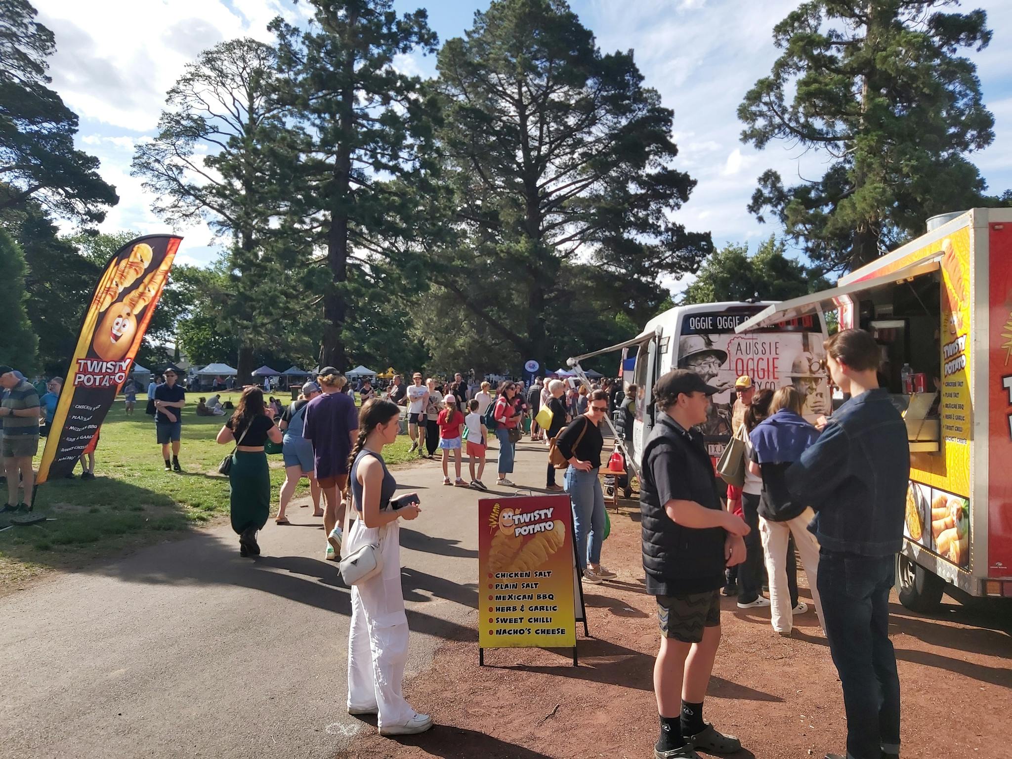 Shoppers and market food vans