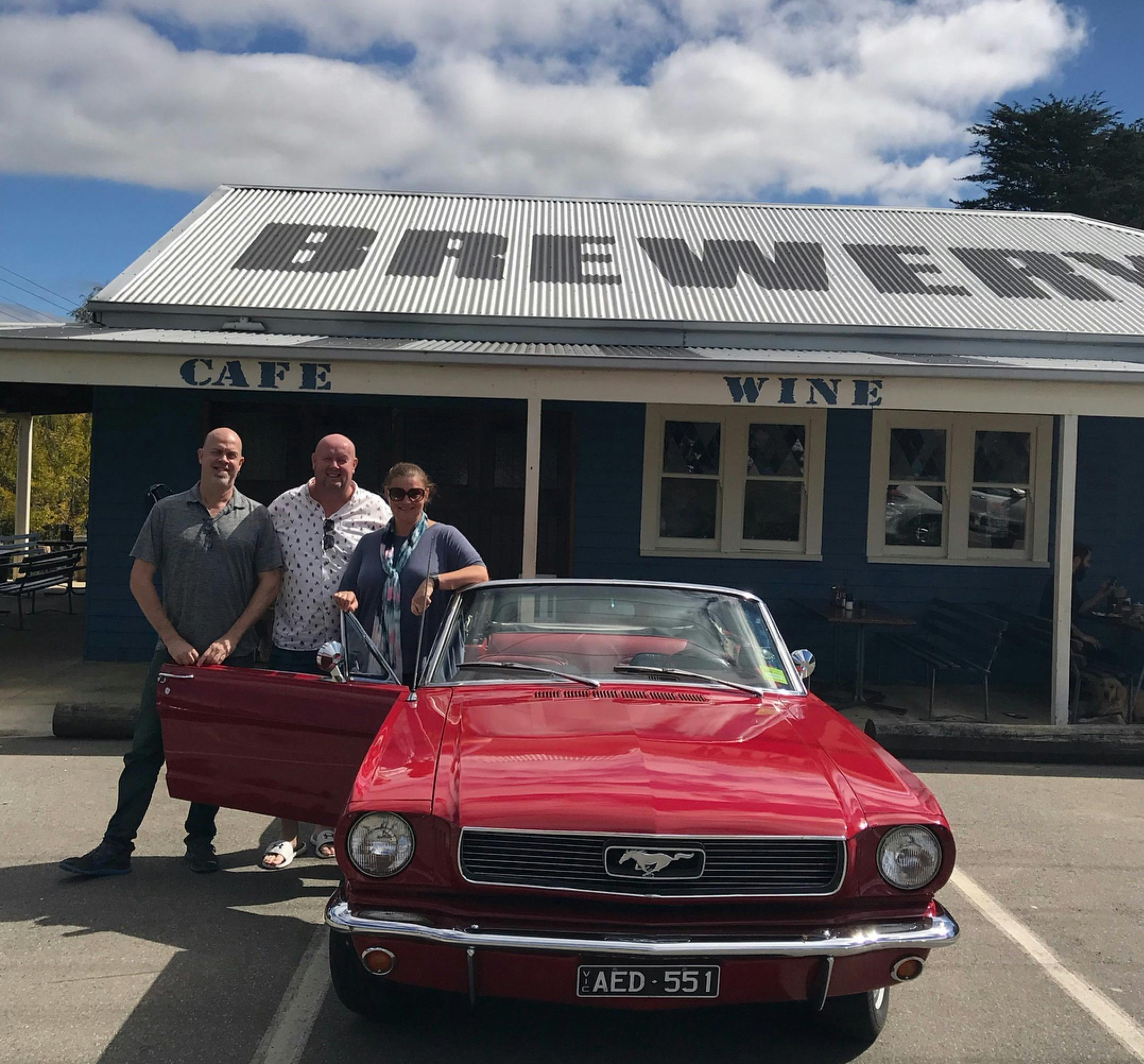 Group of three with Vintage Mustang convertible visiting Forrest brewery in Otway ranges