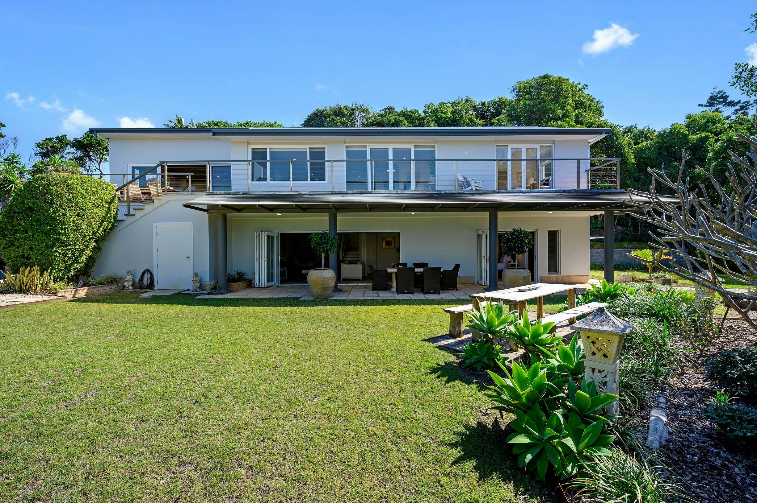 Exterior of house, set in private gardens with private pathway to beach