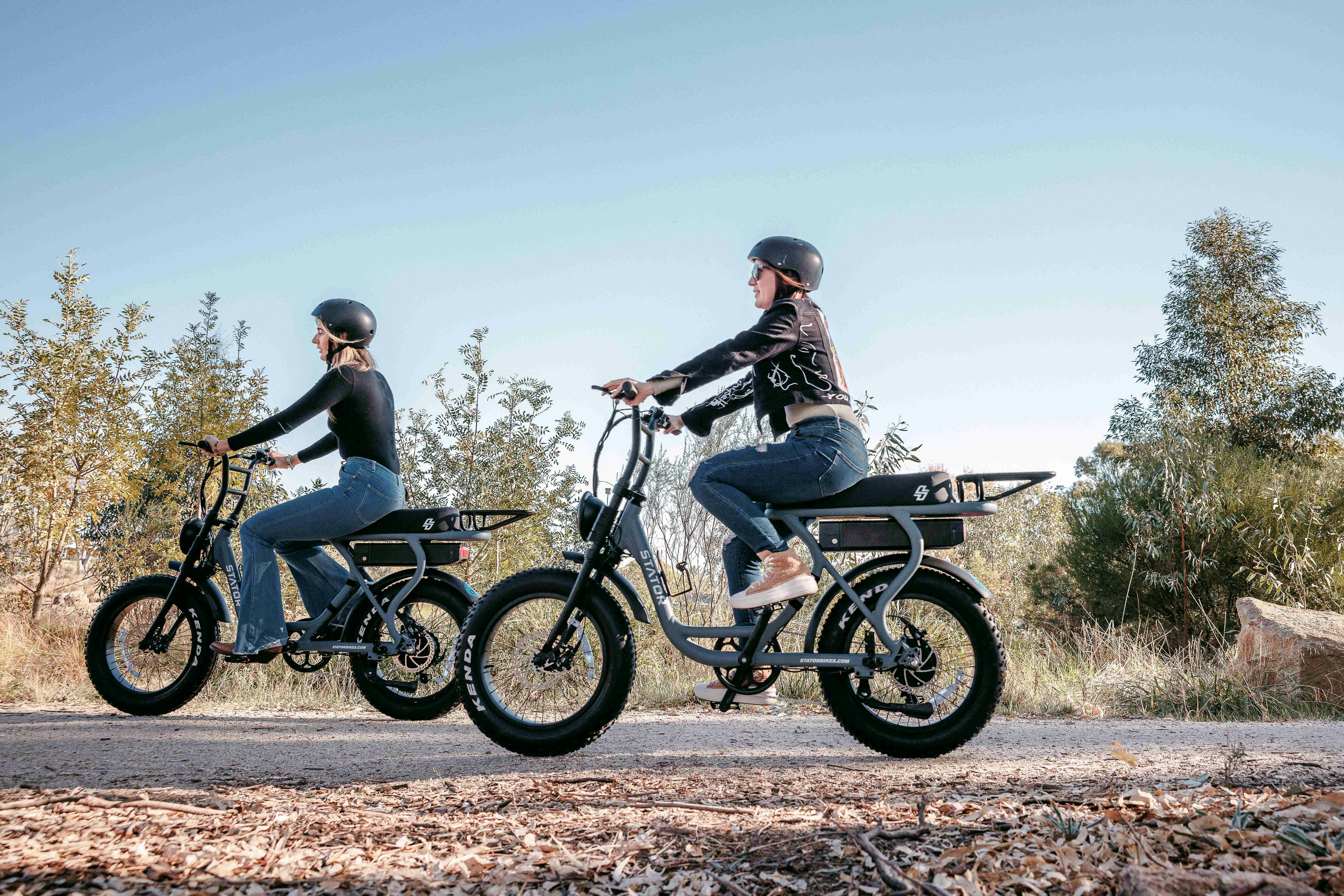 Two friends riding our NEW Stator Club E-Bikes around Lake King Wetlands