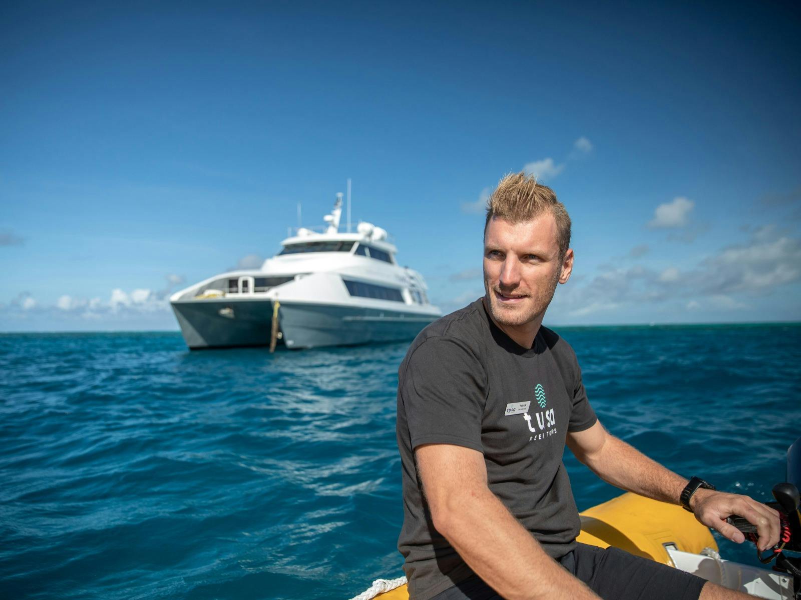 Tusa Reef Tours - crew on guest snorkel safety watch