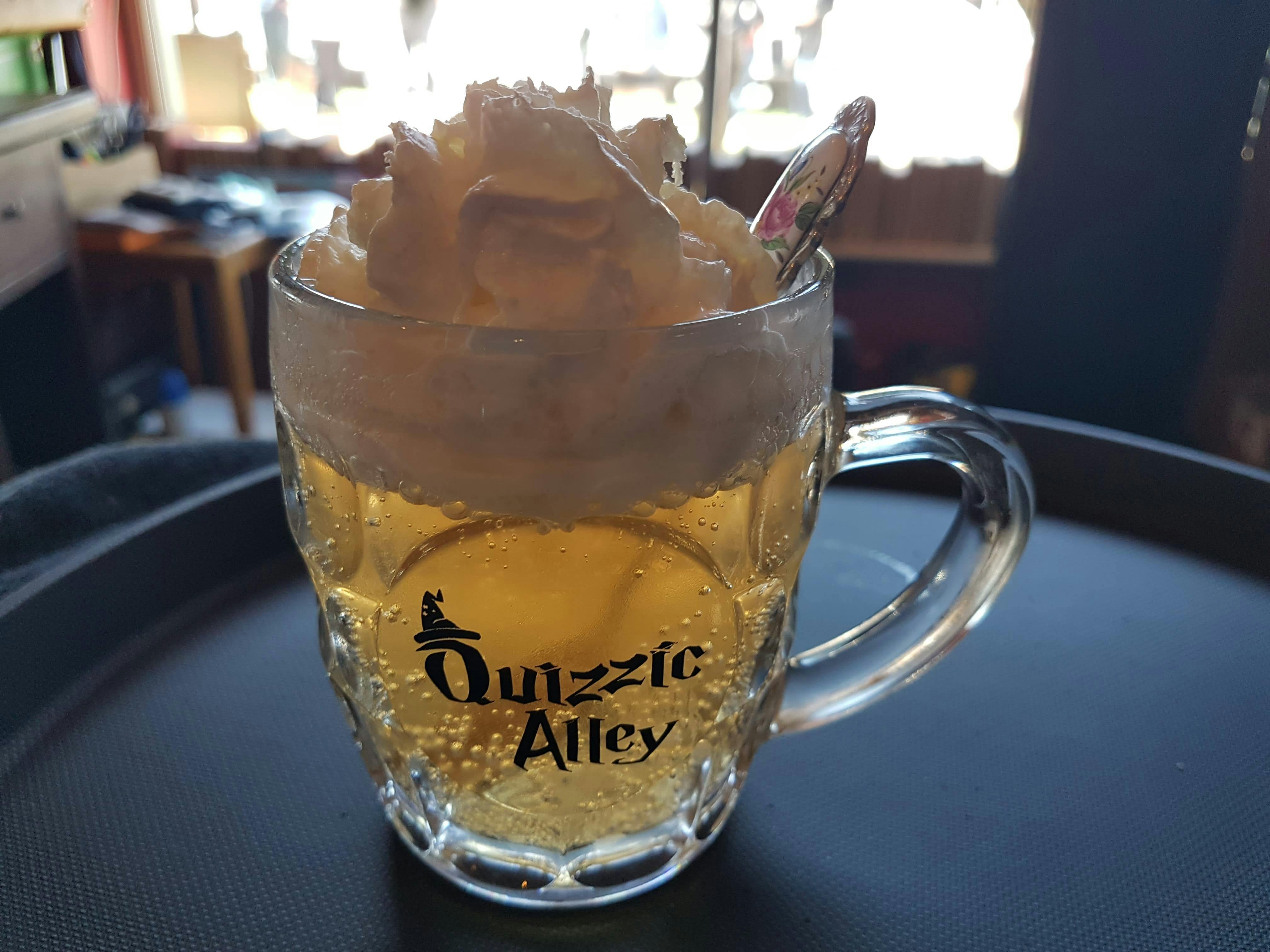 Glass of butterscotch flavoured drink called QBrew