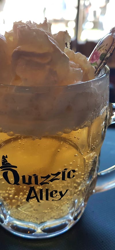 Glass of butterscotch flavoured drink called QBrew
