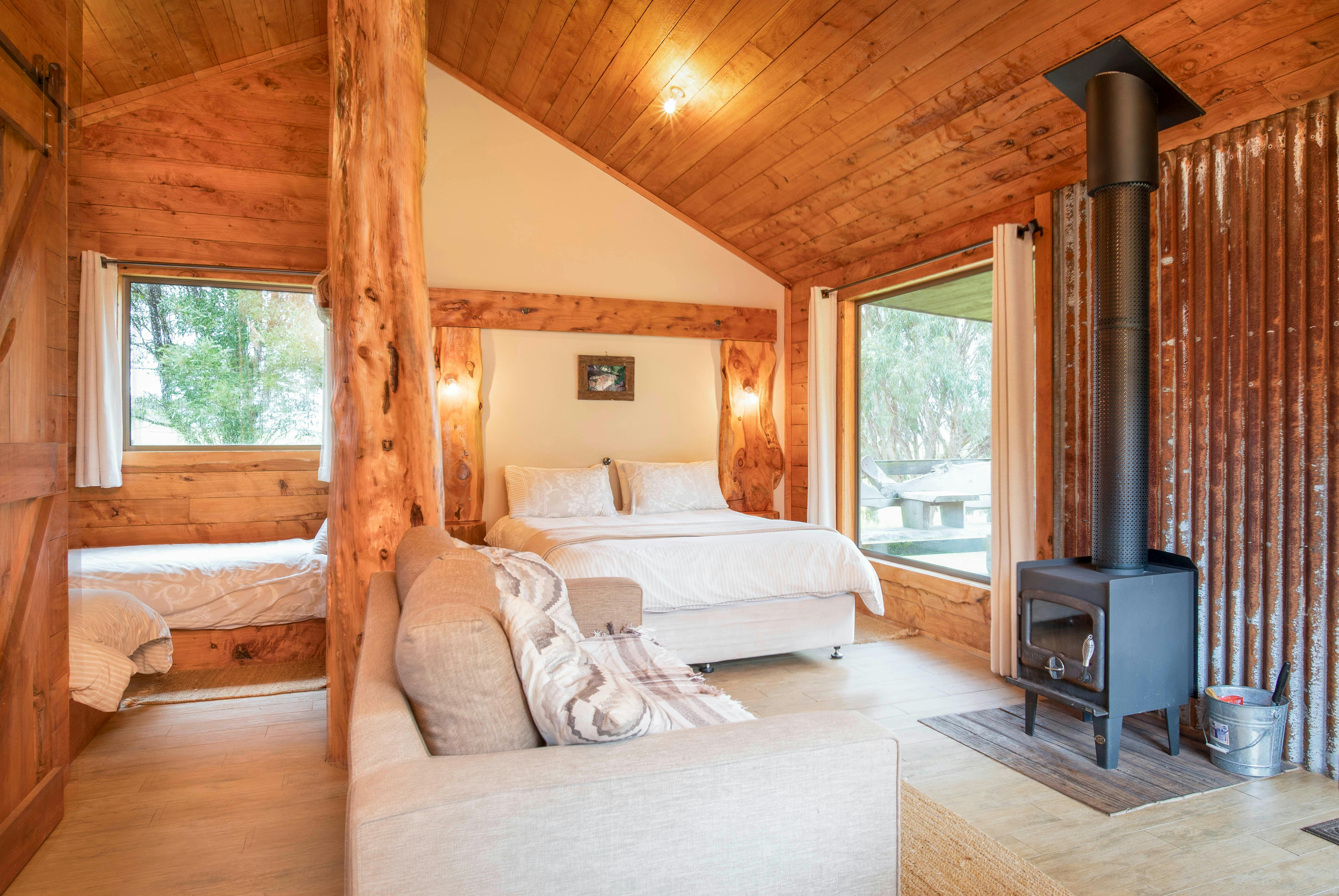 Country Hut - view into bedroom with 2 single beds and Queen Bed