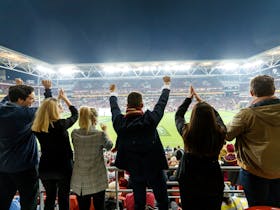 An image of Suncorp Stadium patrons in a corporate facility enjoying an event