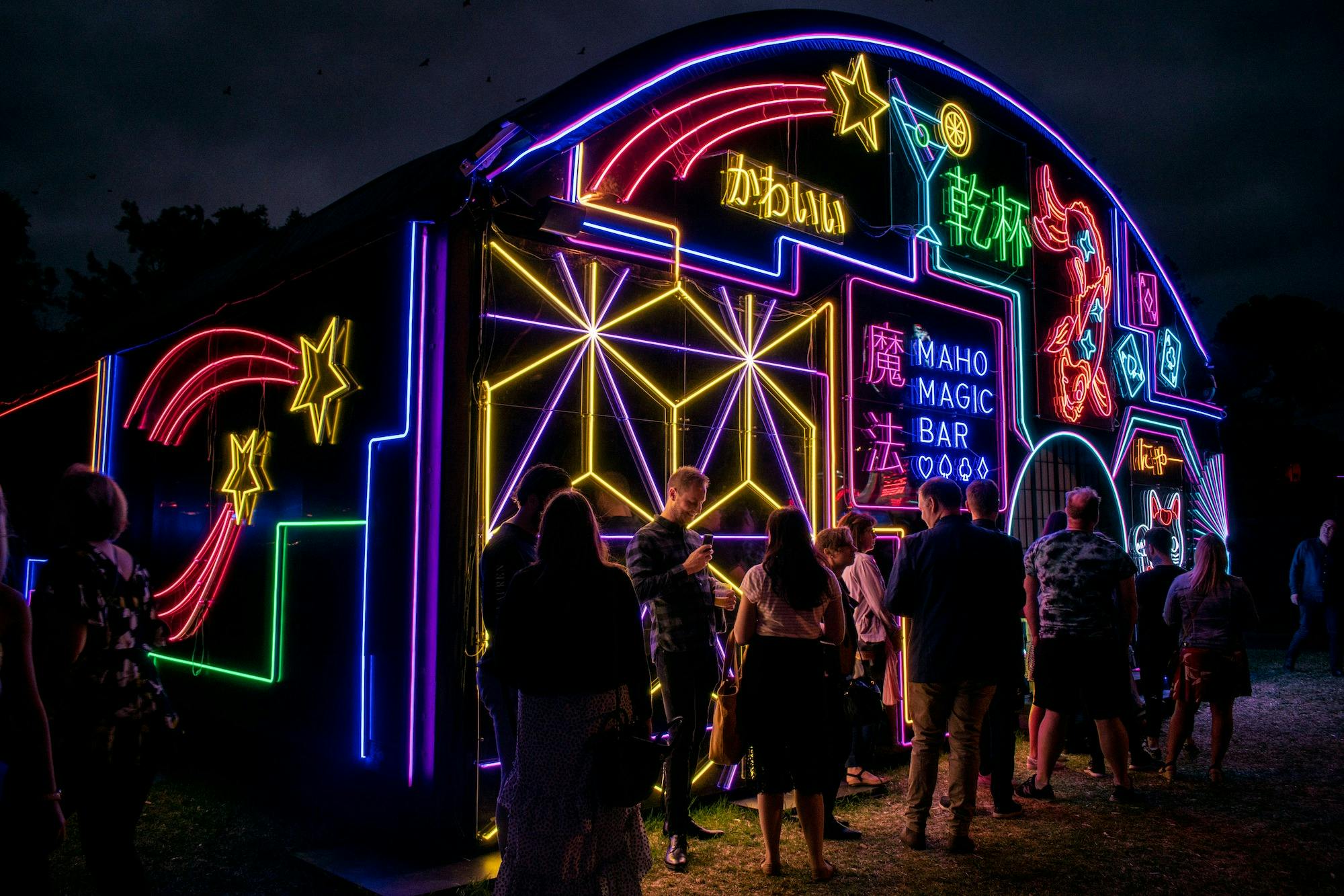 Neon lit venue with people outside