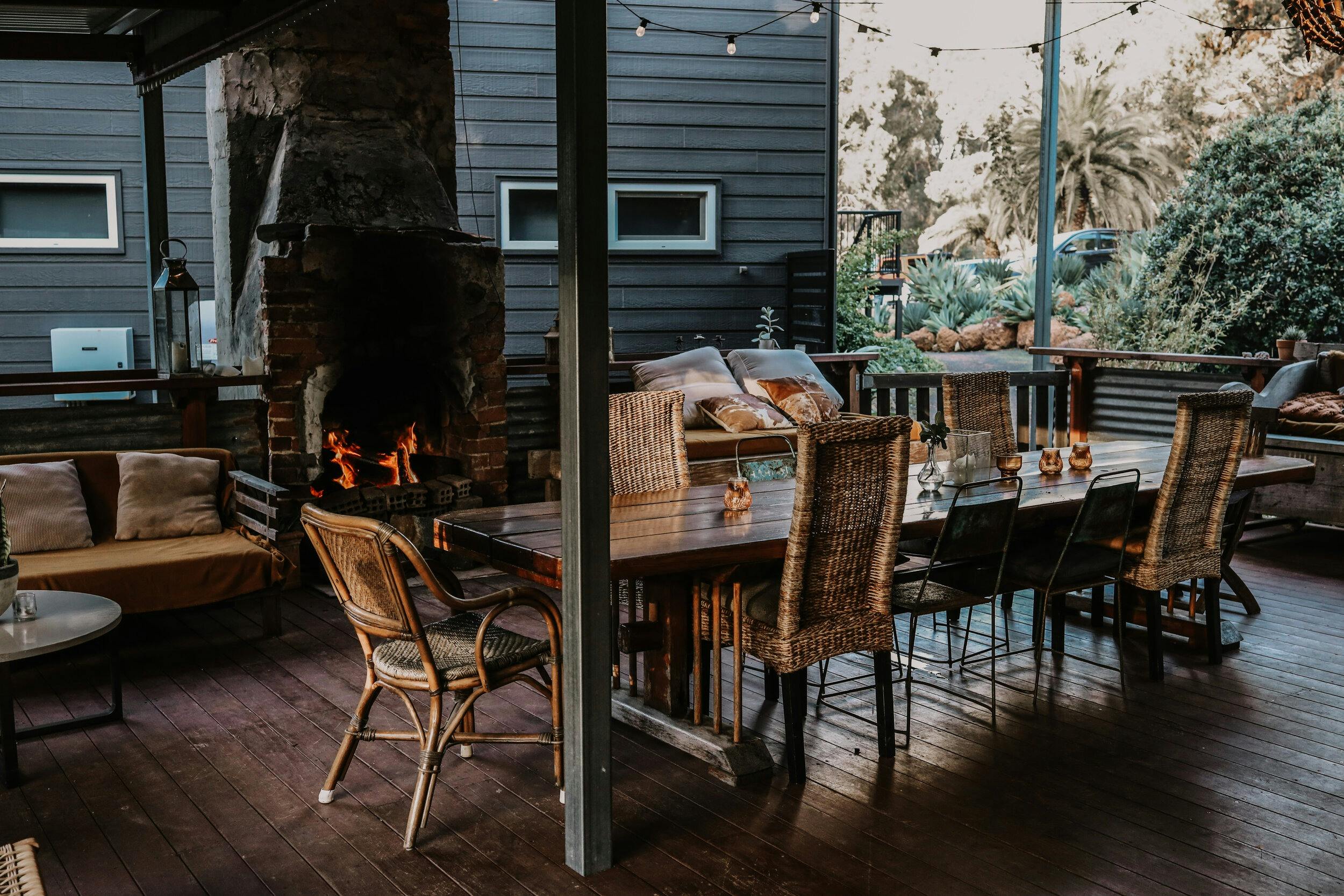 Timber deck and living area with a cosy fireplace and outdoor seating at Premalaya in Yallingup, Wes