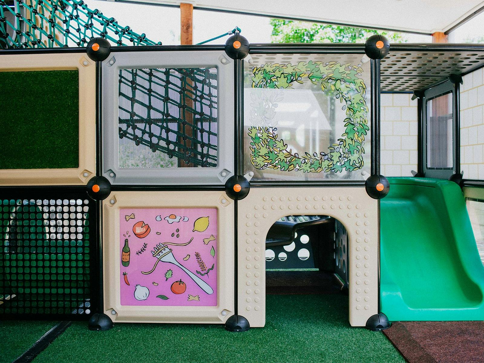 Indoor, covered, and fenced playground for the kids!
