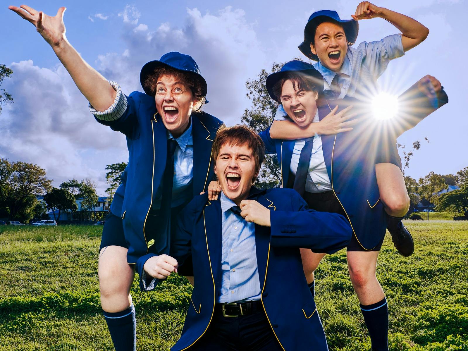 Boys on the ground cheering. One person on the back of another arm in the air cheering.
