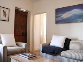 Living room seating area with timber floors and heritage details at 1856 Cottage in Robe South Austr