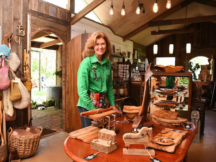 Female stands amongst handcrafted items within the shop at Larrikins Lock-up