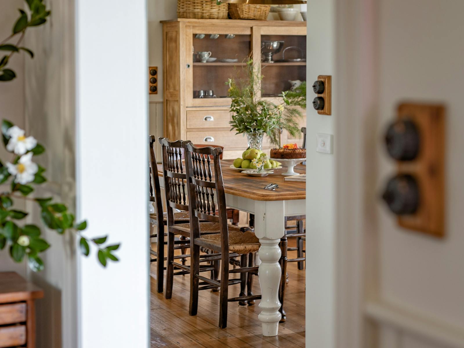 Looking into kitchen/dining room. Tas oak kitchen dresser, dining table, antique dining chairs.