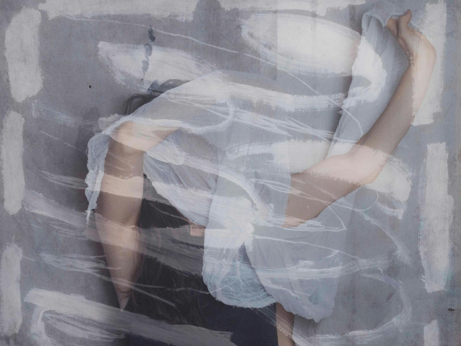 Layered image of reclining body in sheer fabric, obscured by white brushstrokes on grey.